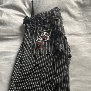 Black and white pinstriped Tripp shorts with skele- animal on back pocket